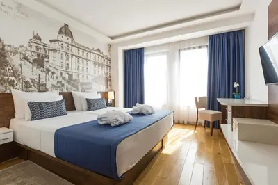 a hotel room with a bed with towels on it at Abba Hotel in Belgrade