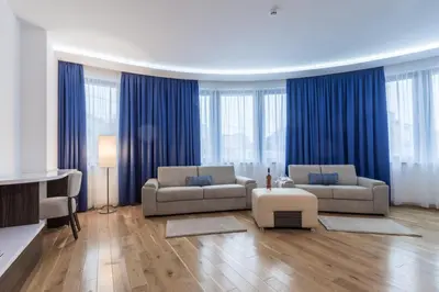 a living room with two couches and blue curtains at Abba Hotel in Belgrade