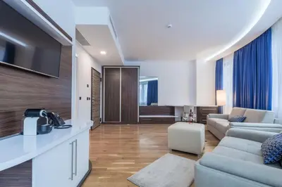 a living room with a couch and a table at Abba Hotel in Belgrade