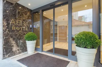 a store front with two large white pots with plants in it at Abba Hotel in Belgrade