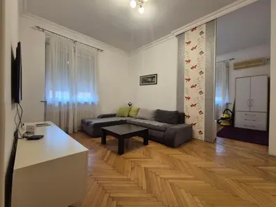 a living room with a couch and a table at Dositej 5 Apartment in Belgrade