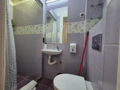 a small bathroom with a toilet and a sink at Dositej 5 Apartment in Belgrade