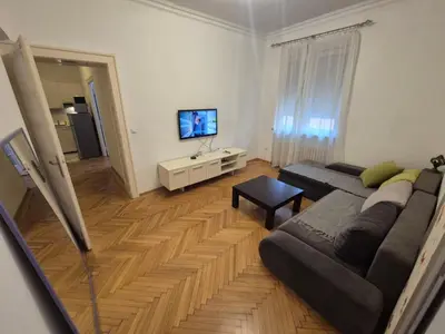 a living room with a couch and a flat screen tv at Dositej 5 Apartment in Belgrade