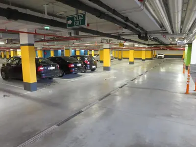 a parking garage with cars parked in it at Garden Apartment Sun City in Belgrade