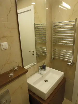 a bathroom with a white sink and a mirror at Garden Apartment Sun City in Belgrade