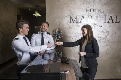 a woman standing next to a man in a hotel room at Hotel Marshal Garni in Belgrade