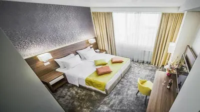 a hotel room with a bed and a window at Hotel Marshal Garni in Belgrade