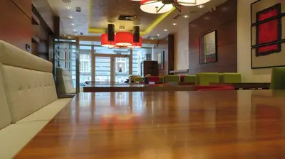 a dining room with a table and chairs and a lobby at Hotel Marshal Garni in Belgrade