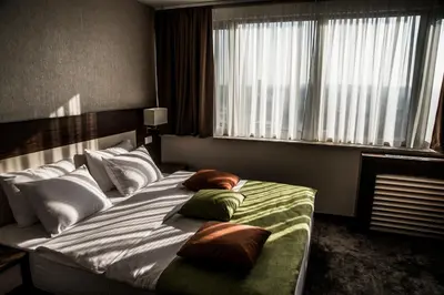 a bedroom with a large bed with pillows on it at Hotel Marshal Garni in Belgrade