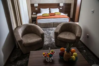 two chairs and a table in a hotel room at Hotel Marshal Garni in Belgrade