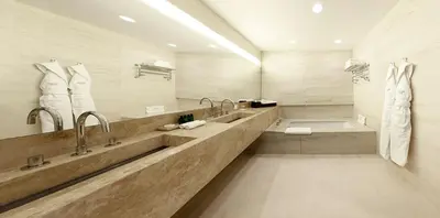 a large bathroom with two sinks and a tub at Square Nine Hotel Belgrade-The Leading Hotels of The World in Belgrade