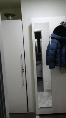 a door to a bathroom with a blue puffer vest at Apartment La Bombonera in Belgrade