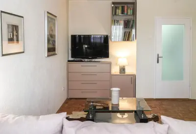 a living room with a tv and a coffee table at Apartment La Bombonera in Belgrade
