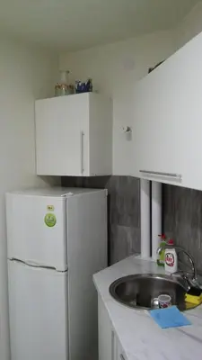 a kitchen with a white refrigerator and a sink at Apartment La Bombonera in Belgrade