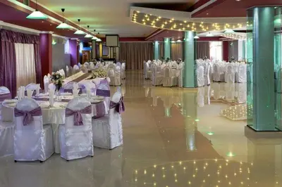 a banquet hall with white tables and white chairs at B&B Queen in Belgrade