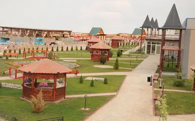 a park with a playground with a slide and rides at B&B Queen in Belgrade