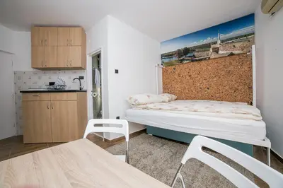 a small room with a bed and a kitchen at City Panorama in Belgrade