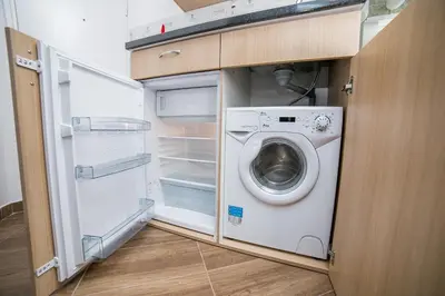a washer and dryer in a small kitchen at City Panorama in Belgrade