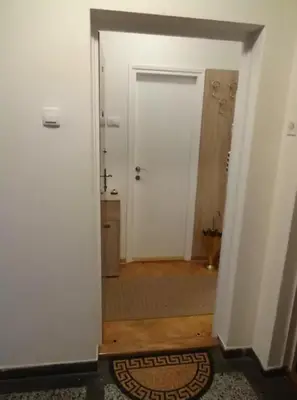 a hallway with a door leading to a bathroom at Modern Cozy Apartment in Belgrade