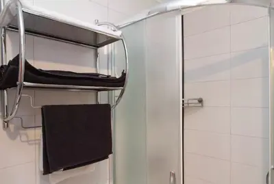 a towel rack in a bathroom with a shower at Modern Cozy Apartment in Belgrade