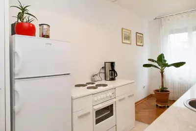 a kitchen with a white stove and a refrigerator at Modern Cozy Apartment in Belgrade