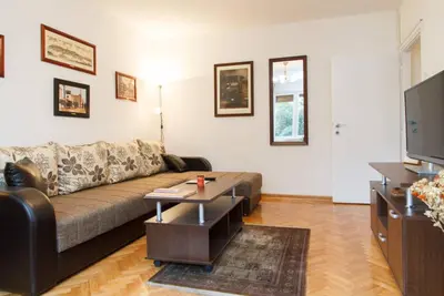 a living room with a couch and a tv at Modern Cozy Apartment in Belgrade