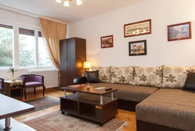 a living room with a couch and a table at Modern Cozy Apartment in Belgrade