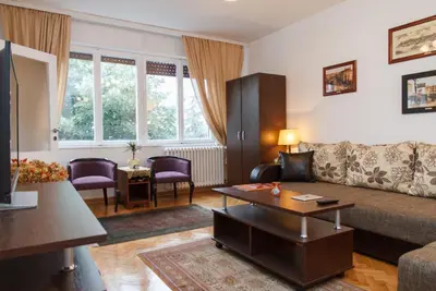 a living room with a couch and a table at Modern Cozy Apartment in Belgrade