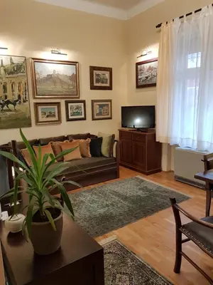 a living room with a couch and a tv at Classic Style Apartment in Belgrade