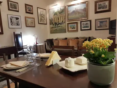a dining room table with a vase of flowers on it at Classic Style Apartment in Belgrade