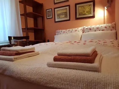 a bedroom with a bed with towels on it at Classic Style Apartment in Belgrade