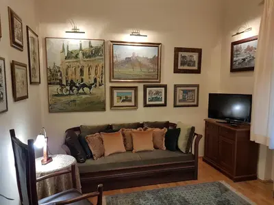 a living room with a couch and pictures on the wall at Classic Style Apartment in Belgrade