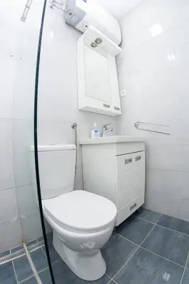 a bathroom with a white toilet and a mirror at Balkan-inn Apartment Terazije in Belgrade