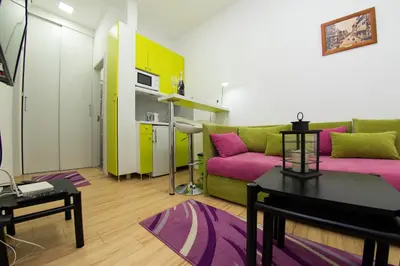 a living room with a couch and a table at Balkan-inn Apartment Terazije in Belgrade
