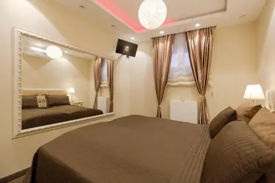 a bedroom with a bed and a large mirror at Central Business Apartments Jacuzzi in Belgrade