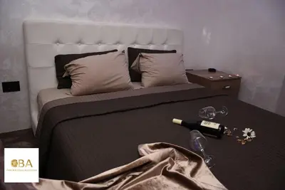 a bedroom with a bed with a bottle of wine on it at Central Business Apartments Jacuzzi in Belgrade