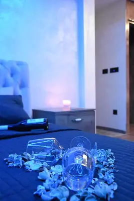 a table with a blue table cloth with glasses on it at Central Business Apartments Jacuzzi in Belgrade
