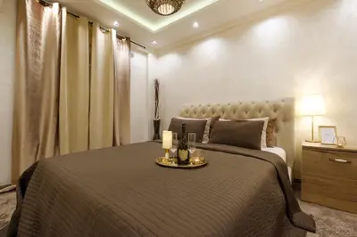 a bedroom with a bed with a tray with candles on it at Central Business Apartments Jacuzzi in Belgrade