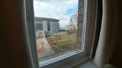 a window with a view of a building at Arena East Apartment in Belgrade