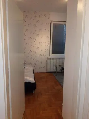 an empty room with a bed and a window at Apartment Aska in Belgrade