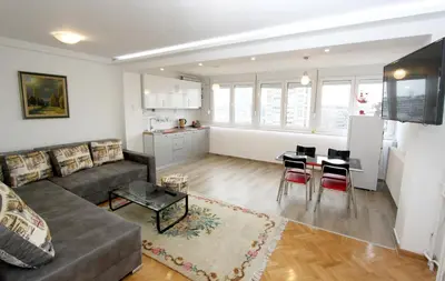 a living room with a couch and a table at Penthouse Novi Beograd in Belgrade