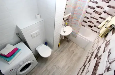 a bathroom with a white toilet and a sink at Penthouse Novi Beograd in Belgrade