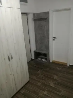 an empty room with a door and a fireplace at Penthouse Novi Beograd in Belgrade
