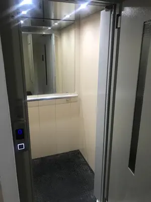 a elevator in a room with a door with a mirror at Penthouse Novi Beograd in Belgrade