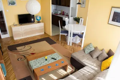a living room with a couch and a table at Sunny Apartment in Belgrade