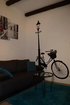 a living room with a bike parked next to a lamp at Saramala Apartment in Belgrade