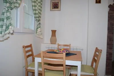 a dining room table with chairs and a bowl on it at Saramala Apartment in Belgrade