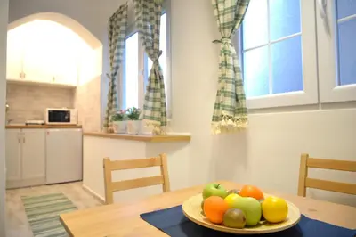 a plate of fruit on a table in a kitchen at Saramala Apartment in Belgrade