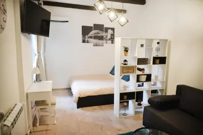 a bedroom with a bed and a white book shelf at Saramala Apartment in Belgrade