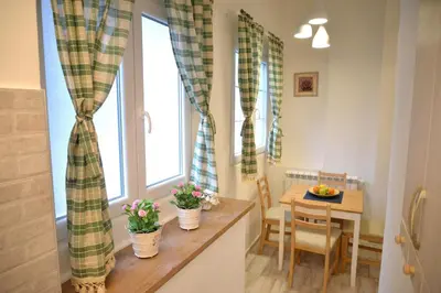 a small dining room with a table and a window at Saramala Apartment in Belgrade